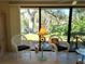 Cozy sunroom with views to the lake and outdoor landscaping at 3818 Sun Eagle Ln, Bradenton, FL 34210