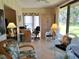 Bright sunroom features tile floors, wicker furniture, and view to the outside at 3818 Sun Eagle Ln, Bradenton, FL 34210