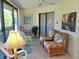 Cozy sunroom featuring wicker furniture, tile floors, and sliding glass doors to the outdoors at 3818 Sun Eagle Ln, Bradenton, FL 34210