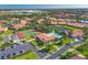 Aerial view of community, showcasing the pool, tennis courts, and lush landscaping at 3880 Wilshire Cir # 28, Sarasota, FL 34238