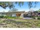 Home's backyard features a partially enclosed patio, exterior chimney, and flowering plants at 3880 Wilshire Cir # 28, Sarasota, FL 34238
