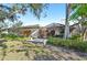 A lush backyard features a partially enclosed patio, exterior chimney, and flowering plants at 3880 Wilshire Cir # 28, Sarasota, FL 34238