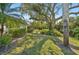Lush backyard featuring mature trees and well-maintained landscaping at 3880 Wilshire Cir # 28, Sarasota, FL 34238