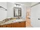 Bathroom features granite countertop, framed mirror and doorway to Primary bedroom at 3880 Wilshire Cir # 28, Sarasota, FL 34238