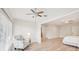 Open floor plan with light wood flooring, white ceilings with fans, and an accent chair at 3880 Wilshire Cir # 28, Sarasota, FL 34238