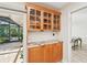 Butler's pantry with granite countertops and glass-front cabinets for storing glassware and beverages at 3880 Wilshire Cir # 28, Sarasota, FL 34238