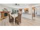 Dining area with fireplace next to open kitchen featuring wood cabinets and stainless appliances at 3880 Wilshire Cir # 28, Sarasota, FL 34238