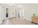 Bright home entryway featuring hardwood floors, double doors with sidelights, and modern light fixtures at 3880 Wilshire Cir # 28, Sarasota, FL 34238