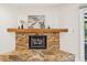 Stone fireplace with mantle and decor, creating a cozy and inviting focal point at 3880 Wilshire Cir # 28, Sarasota, FL 34238