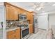 Kitchen featuring stainless steel appliances, light wood cabinets, and granite countertops at 3880 Wilshire Cir # 28, Sarasota, FL 34238