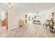 Open-concept living area with hardwood floors, modern decor, and a glimpse into the kitchen at 3880 Wilshire Cir # 28, Sarasota, FL 34238