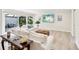 Inviting living room featuring stylish white sofas, a woven coffee table, and sliding glass doors to the patio at 3880 Wilshire Cir # 28, Sarasota, FL 34238