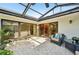 Covered patio with tile flooring, ceiling fan, outdoor furniture and decorative plants at 3880 Wilshire Cir # 28, Sarasota, FL 34238