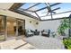 Enclosed patio with tile flooring, ceiling fan, outdoor furniture and decorative plants at 3880 Wilshire Cir # 28, Sarasota, FL 34238