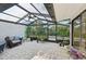 Enclosed patio with tile flooring, ceiling fan, plants and lounge chair at 3880 Wilshire Cir # 28, Sarasota, FL 34238