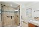 Walk in shower with glass door, tile surround and window at 3880 Wilshire Cir # 28, Sarasota, FL 34238