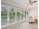 Sun room with white blinds, ceiling fan and chair with nautical star pattern at 3880 Wilshire Cir # 28, Sarasota, FL 34238