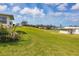 Expansive backyard with lush lawn and views of a tranquil lake community at 4304 14Th E St, Ellenton, FL 34222