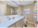 Bathroom features a large mirror, a blue countertop, and a shower with colorful curtains at 4304 14Th E St, Ellenton, FL 34222