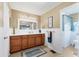 Well-lit bathroom features a wood vanity with modern lighting and a white-walled water closet at 4304 14Th E St, Ellenton, FL 34222