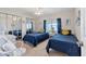 Bedroom features two twin beds with mirrored closet doors and a side table with a lamp at 4304 14Th E St, Ellenton, FL 34222