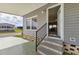 Inviting front entrance with three steps, gray siding, and a partial view of the living area at 4304 14Th E St, Ellenton, FL 34222
