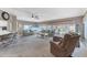 Spacious living room with plush carpeting, modern furniture, and abundant natural light from large windows at 4304 14Th E St, Ellenton, FL 34222