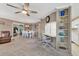 Open-concept living area with built-in shelving, adjacent to the dining area and kitchen bar with seating at 4304 14Th E St, Ellenton, FL 34222