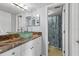 Well-lit bathroom with a modern vanity, glass vessel sink, and a shower with patterned curtain at 4532 La Jolla Dr, Bradenton, FL 34210