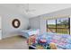 Bright bedroom features neutral walls, ceiling fan and an outdoor balcony at 4532 La Jolla Dr, Bradenton, FL 34210