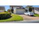 Charming home exterior with a well-manicured lawn, attached garage, and private entrance gate at 4532 La Jolla Dr, Bradenton, FL 34210