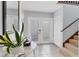 Inviting foyer with tile flooring, staircase, coat closet, and decorative accents at 4532 La Jolla Dr, Bradenton, FL 34210