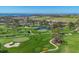Picturesque aerial view of the golf course surrounded by lush greenery and water at 4532 La Jolla Dr, Bradenton, FL 34210