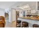 Open-concept kitchen with granite countertops, barstool seating, and modern appliances at 4532 La Jolla Dr, Bradenton, FL 34210