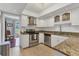 Bright kitchen features stainless steel appliances, granite counters, and white cabinetry at 4532 La Jolla Dr, Bradenton, FL 34210