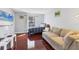 Cozy living room with hardwood floors, comfortable seating, and a large window for natural light at 4532 La Jolla Dr, Bradenton, FL 34210