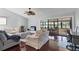 Bright living room featuring hardwood floors, fan and sliding glass doors to the patio at 4532 La Jolla Dr, Bradenton, FL 34210