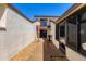 Enclosed patio of a tan stucco home with a grill and outdoor seating at 4532 La Jolla Dr, Bradenton, FL 34210