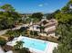 Community pool offers a refreshing escape amidst lush landscaping and clear blue skies at 4532 La Jolla Dr, Bradenton, FL 34210