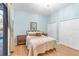 Bedroom with light blue walls and access to the pool through sliding glass doors at 4620 Blue Marlin Dr, Bradenton, FL 34208