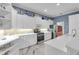 Charming kitchen with white cabinetry, stone countertops, modern appliances, and decorative accents at 4620 Blue Marlin Dr, Bradenton, FL 34208