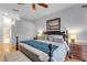 Bright main bedroom featuring a king bed, hardwood floors, and decorative lamps, complemented by neutral wall paint at 4620 Blue Marlin Dr, Bradenton, FL 34208