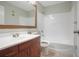 A clean bathroom with a wood vanity, a large mirror, and a shower and tub combo with white tile at 4906 25Th W St # 106, Bradenton, FL 34207