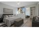 This bedroom features a walk-in closet with mirrored doors, a ceiling fan, and a bench at the end of the bed at 4906 25Th W St # 106, Bradenton, FL 34207