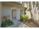 A welcoming exterior view of the home's front entrance framed by a large tree and lush vegetation at 4906 25Th W St # 106, Bradenton, FL 34207