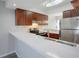 Updated kitchen featuring bright countertops, stainless steel appliances, and warm wood cabinetry at 4906 25Th W St # 106, Bradenton, FL 34207