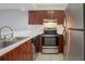 Well-equipped kitchen featuring stainless steel appliances and ample counter space for cooking at 4906 25Th W St # 106, Bradenton, FL 34207