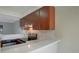 Modern kitchen with white countertops, cherry wood cabinets, and stainless-steel appliances at 4906 25Th W St # 106, Bradenton, FL 34207