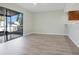 Spacious living room features a large sliding glass door and plank flooring at 4906 25Th W St # 106, Bradenton, FL 34207
