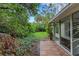 Charming backyard featuring a tiled patio, lush landscaping and peaceful surroundings, creating a tranquil outdoor space at 5019 Village Gardens Dr # 31, Sarasota, FL 34234